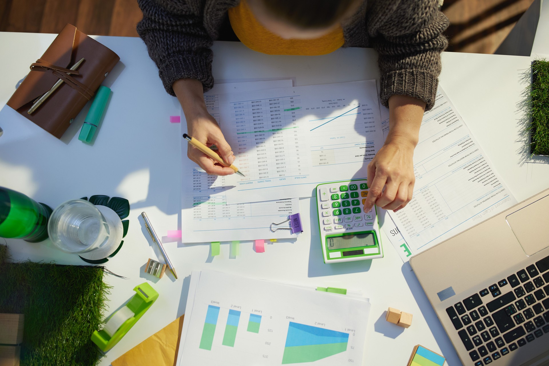 accountant woman with calculator and documents working